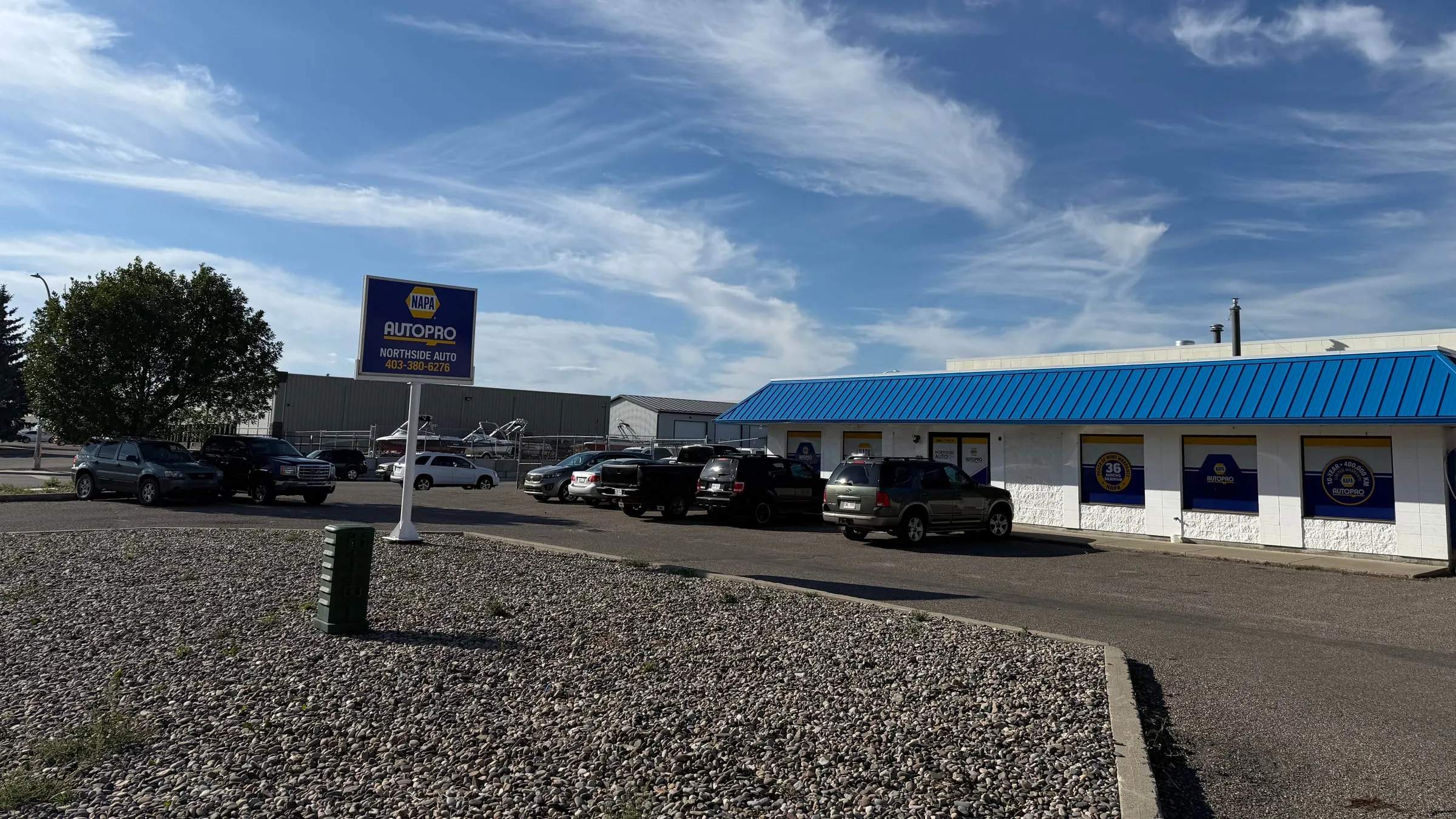 The Northside Auto shop on 12 Avenue North, with its NAPA AUTOPRO sign out front and vehicles parked along the blue awning